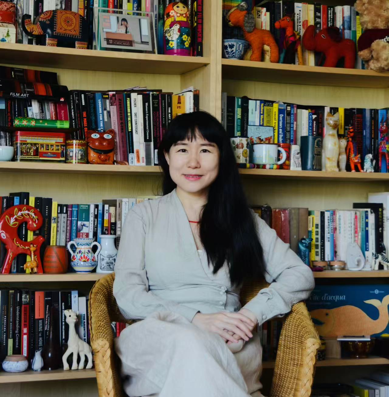 Professor Ling Zhang seated on a chair